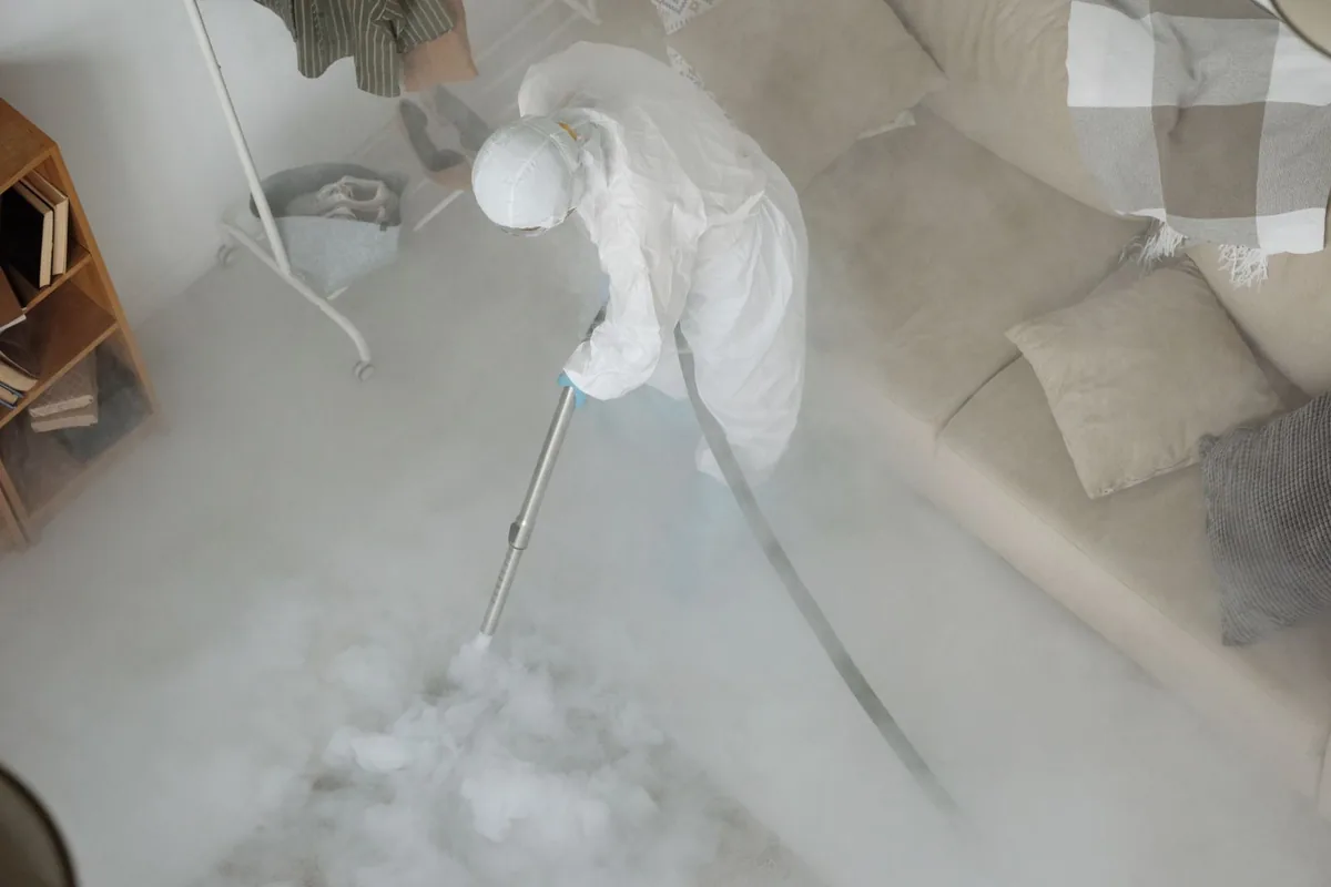 Biohazard cleanup technician in protective equipment, Elmendorf, TX